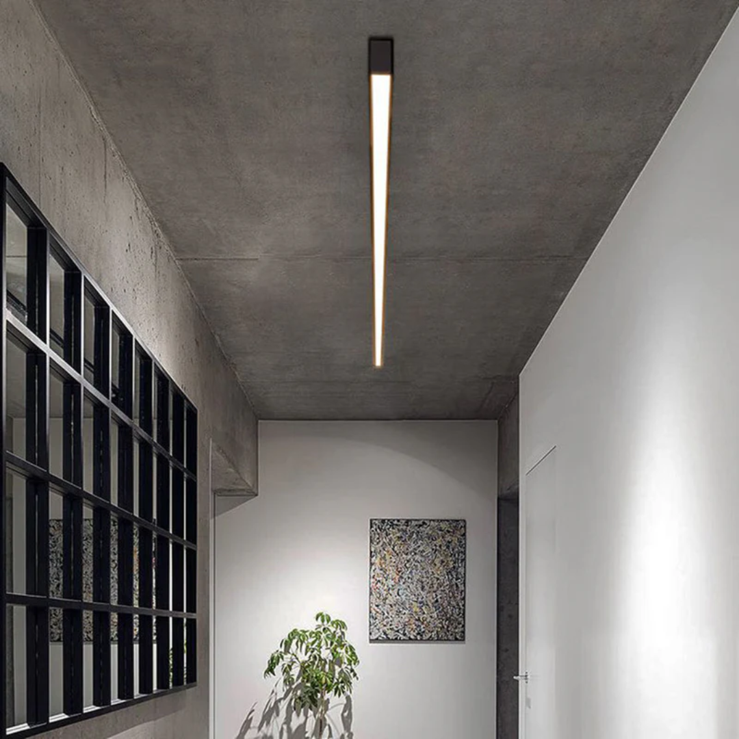 Energy-efficient linear LED ceiling light, industrial style, provides bright modern indoor lighting.