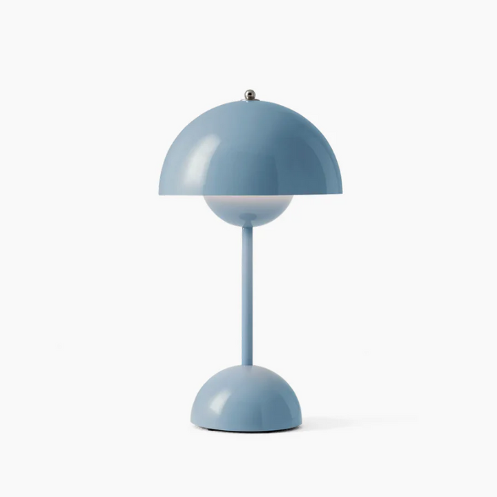LED desk lamp with touch dimming, providing soft ambient lighting in a living room.