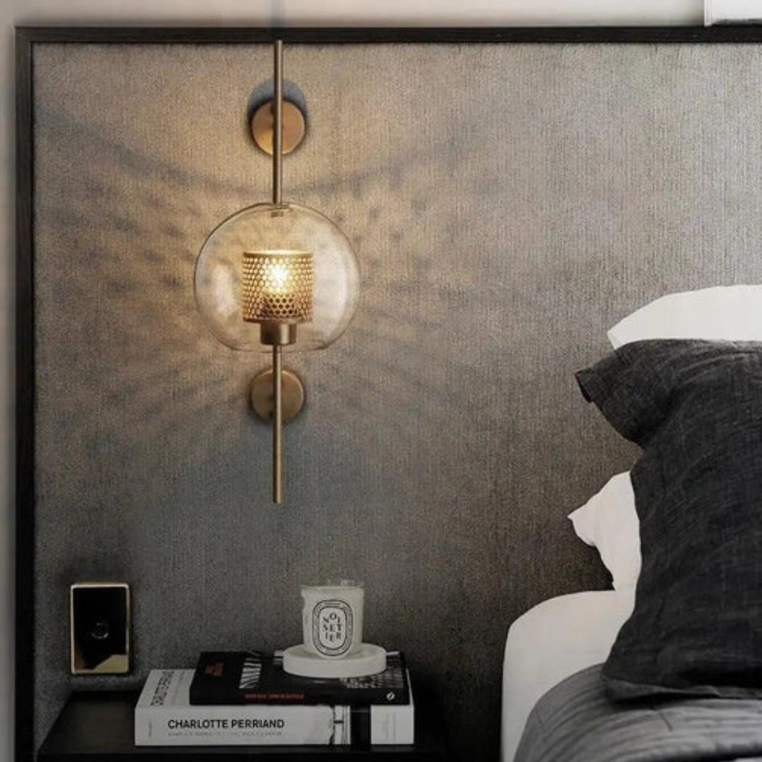 Close-up of a Glasierra modern LED wall lamp, highlighting its clear glass and brushed gold finish.