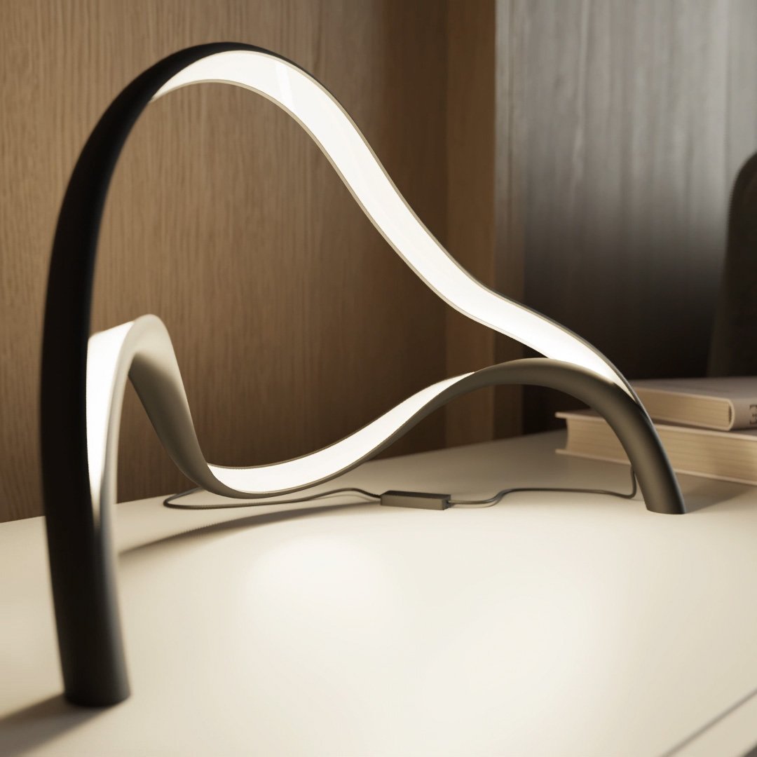Contemporary Arcelle LED desk lamp providing efficient task lighting with its unique sculptural shape.