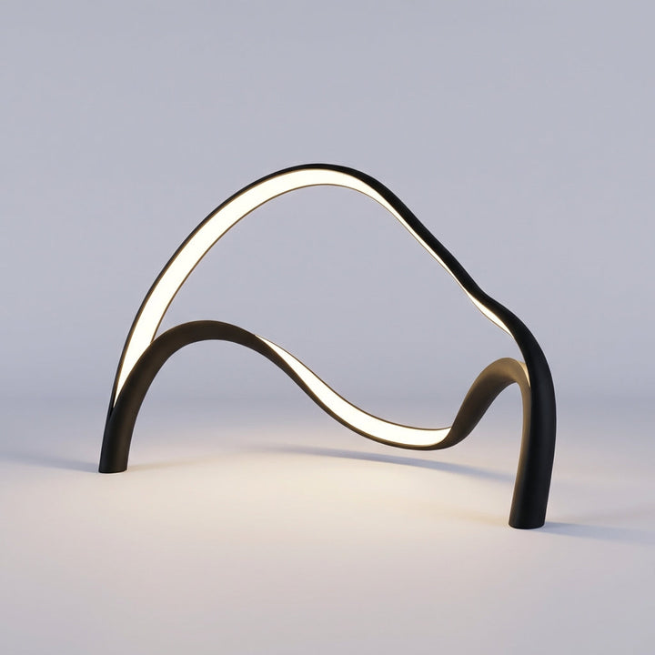 Ambient lighting from an Arcelle modern sculptural LED table lamp, adding warmth to a bedroom.
