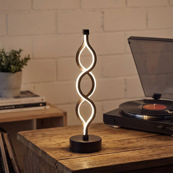 Modern LED Spiral Table Lamp, Spirique, providing ambient lighting for home decor.