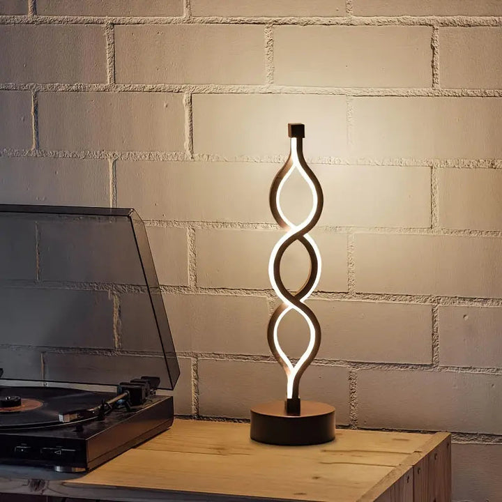 Close-up of a Spirique modern LED table lamp, showcasing its unique spiral light design.