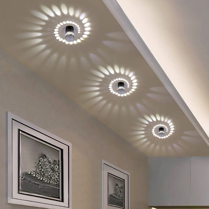 Modern LED Spiral Wall Lamp, black finish, illuminating a contemporary living room.