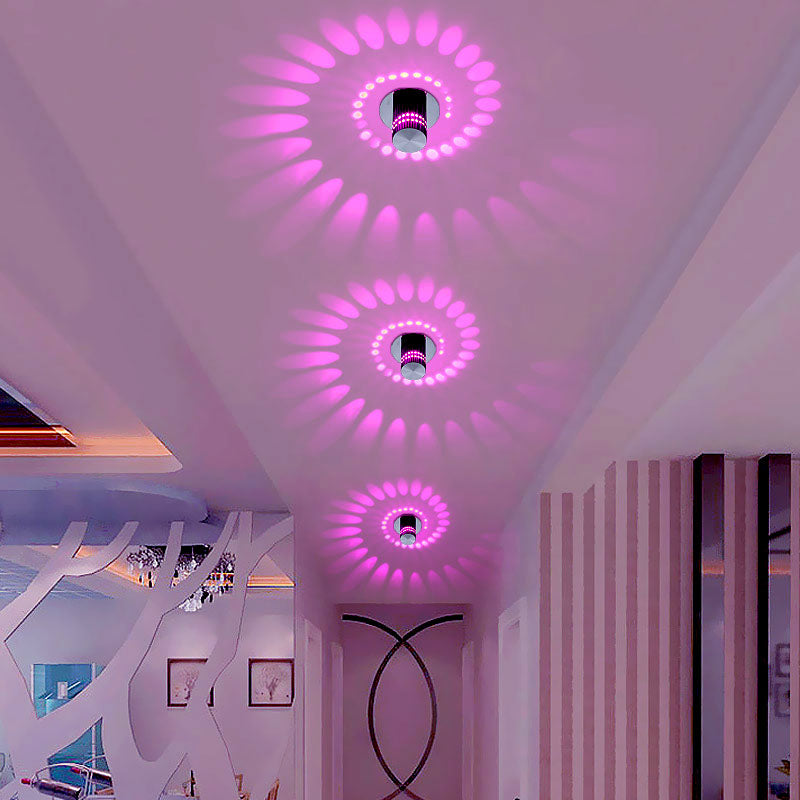 Close-up of a LumoSpiral LED spiral wall sconce, illuminating a contemporary room with soft light