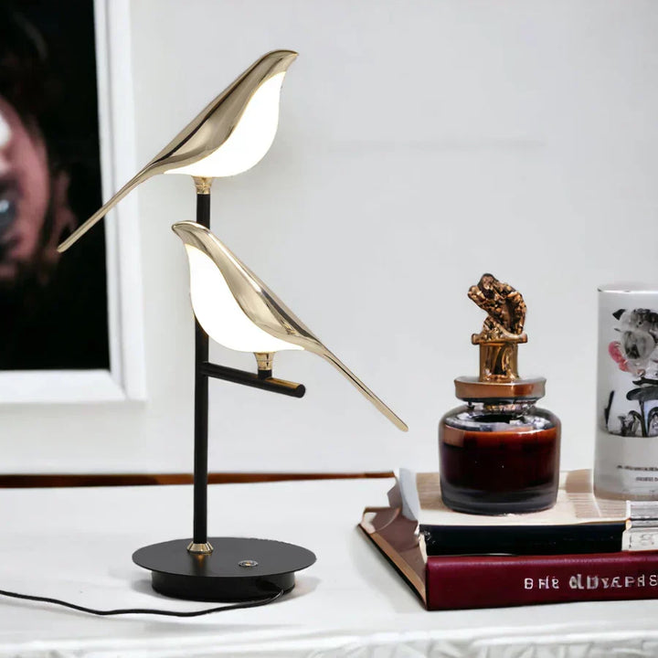 Contemporary gold LED table lamp, AvaBird design, provides ambient light for stylish bedrooms or living rooms.