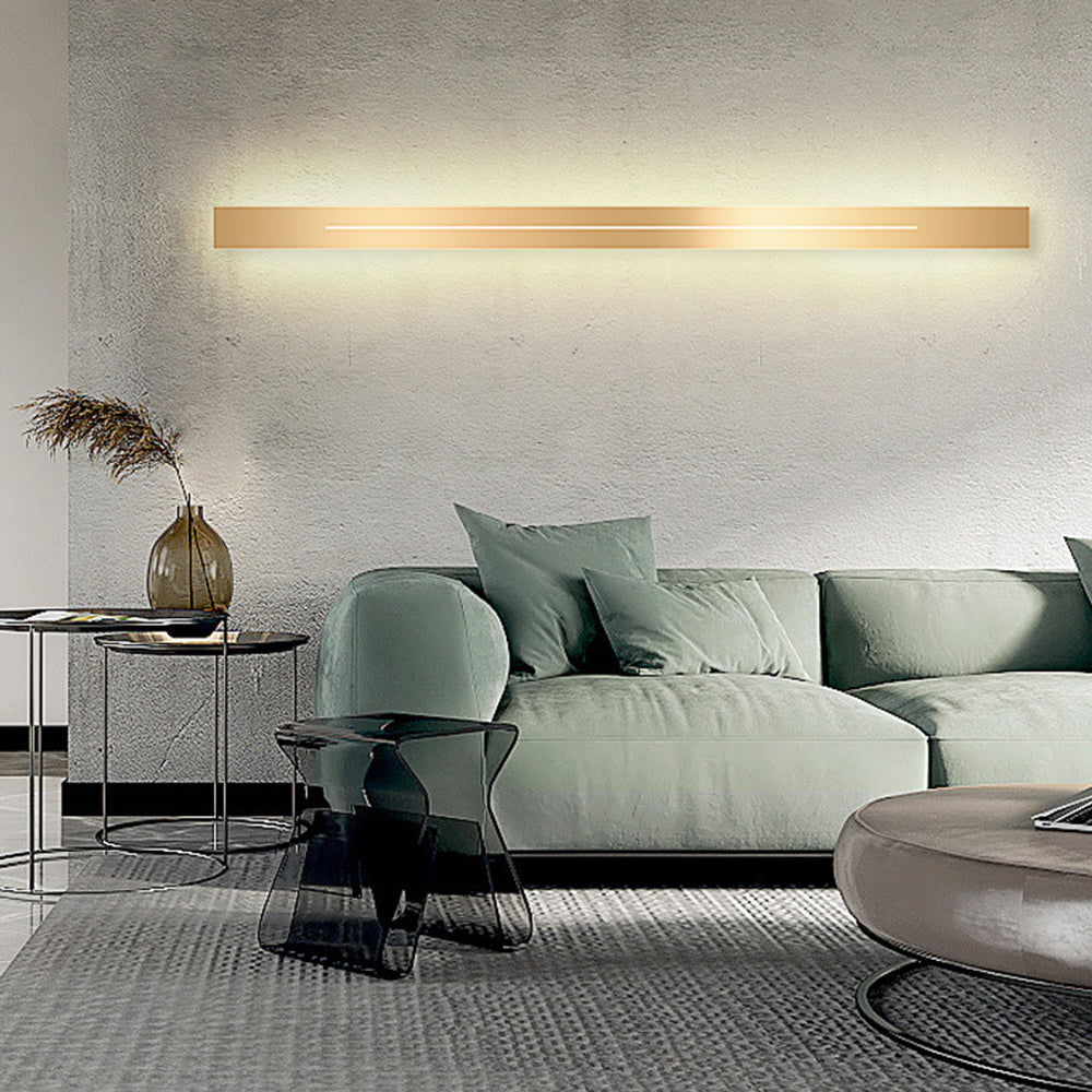Gold finish modern LED wall lamp, adds elegant indoor lighting to home decor.
