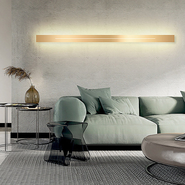 Gold finish modern LED wall lamp, adds elegant indoor lighting to home decor.