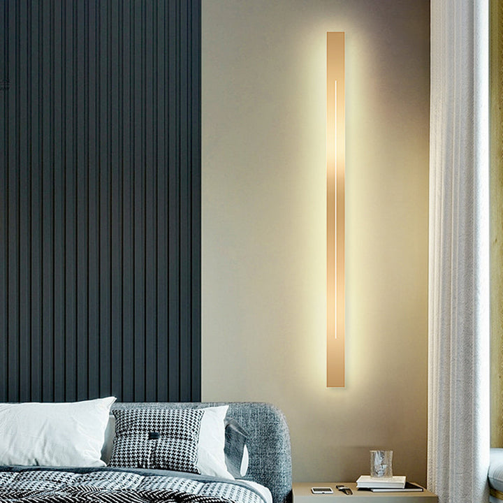 Sleek minimalist gold LED wall light, bright and energy-efficient indoor fixture.