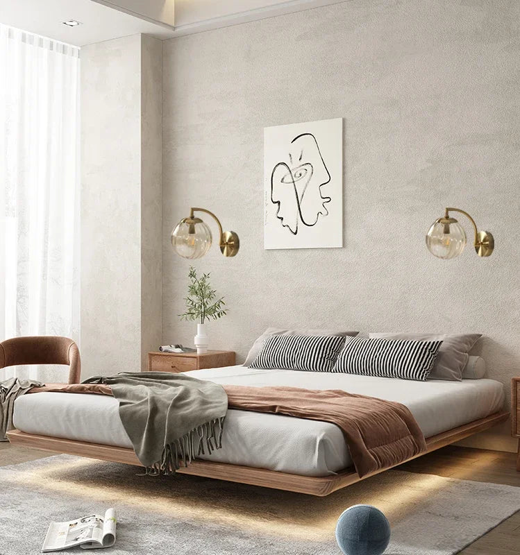 Luxe glass LED wall lamp with ambient glow for stylish bedroom lighting.