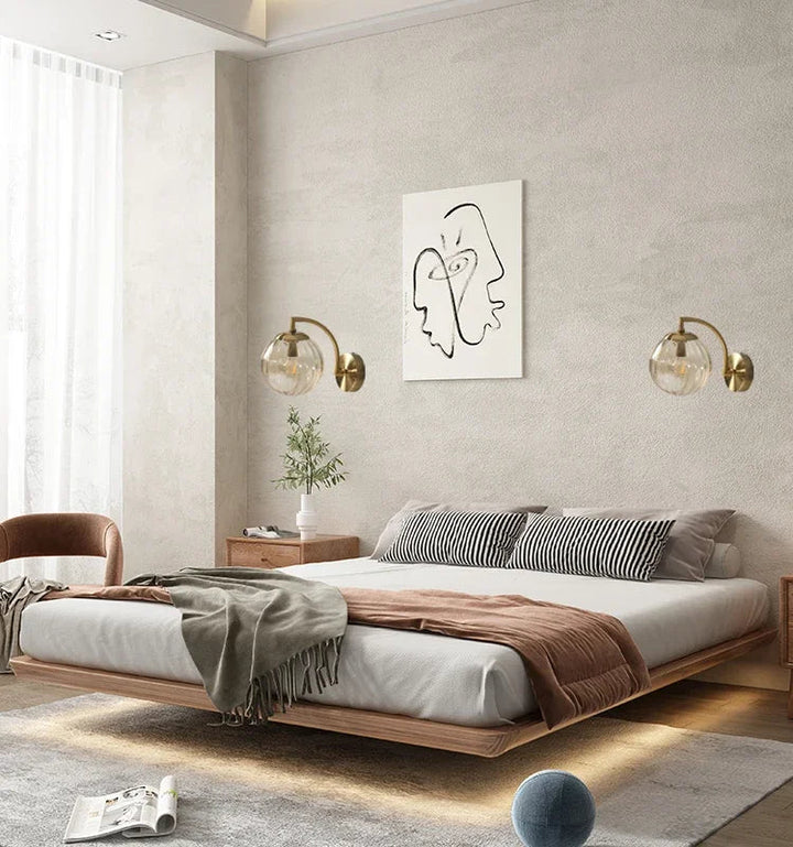 Luxe glass LED wall lamp with ambient glow for stylish bedroom lighting.