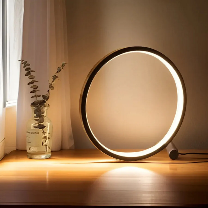 Sleek LumaCircle Dimmable LED night light. Modern table lamp offers adjustable ambient lighting for any room.
