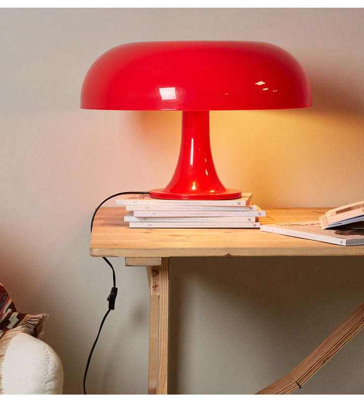 Modern LED toadstool desk lamp, a minimalist bedside light creating a soft, ambient glow.