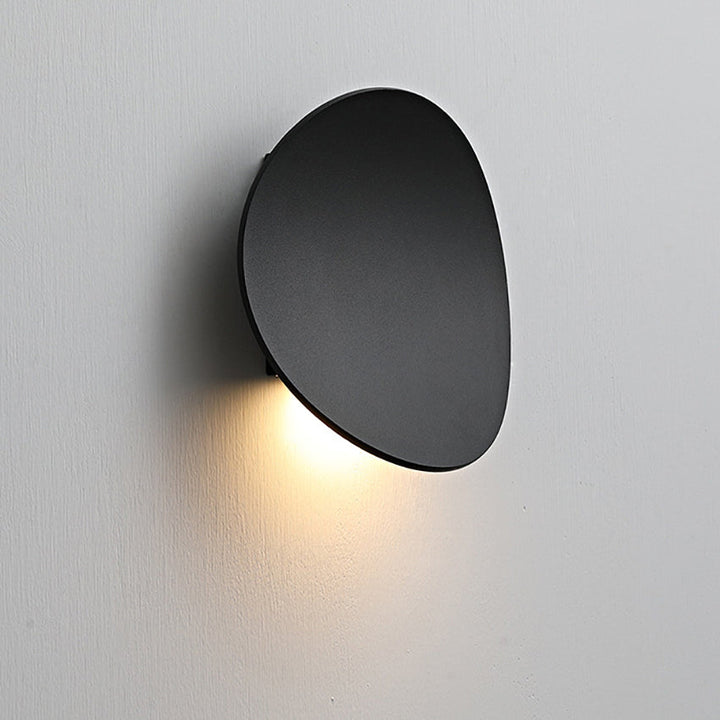 Minimalist LED wall sconce installed, providing modern ambient light for a contemporary room.