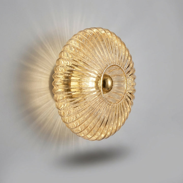 Contemporary glass wall sconce by Aurafold, enhances living room with minimalist lighting.