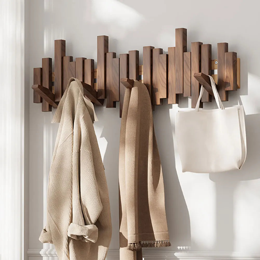 Modern natural wood wall-mounted hanger with 5 foldable hooks for coats, hats & bags. Space-saving entryway decor.