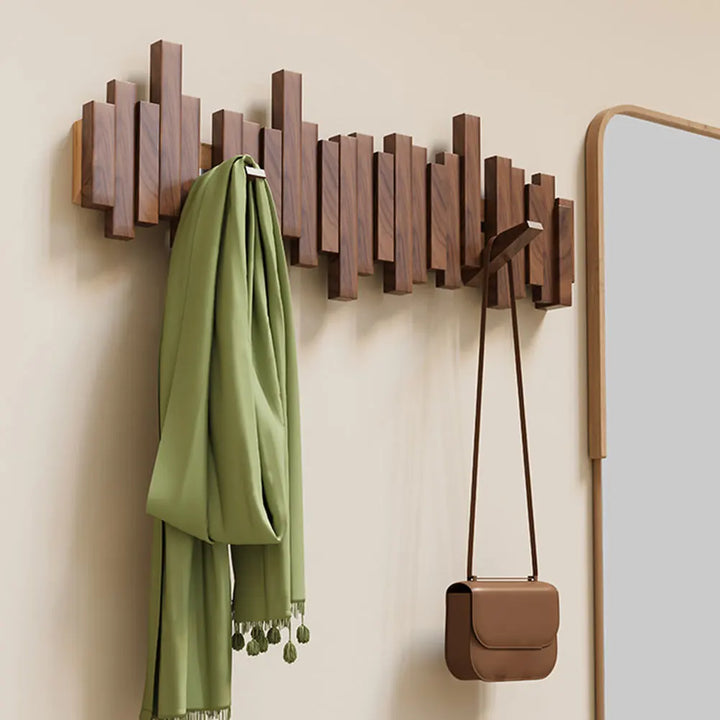 Natural wood wall coat rack with innovative foldable hooks. Perfect for space-saving home organization & modern entryways.
