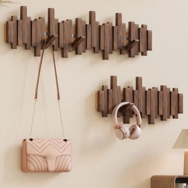 Sleek modern natural wood wall hook rack. Foldable hooks provide smart space-saving storage for coats in your entryway.