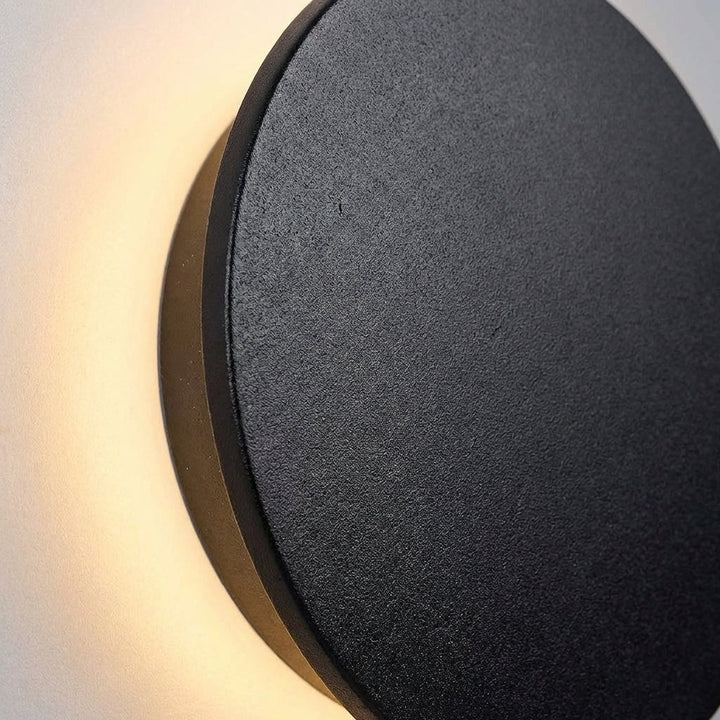 Contemporary Solunex round wall mounted LED light, perfect for modern outdoor and patio ambiance.