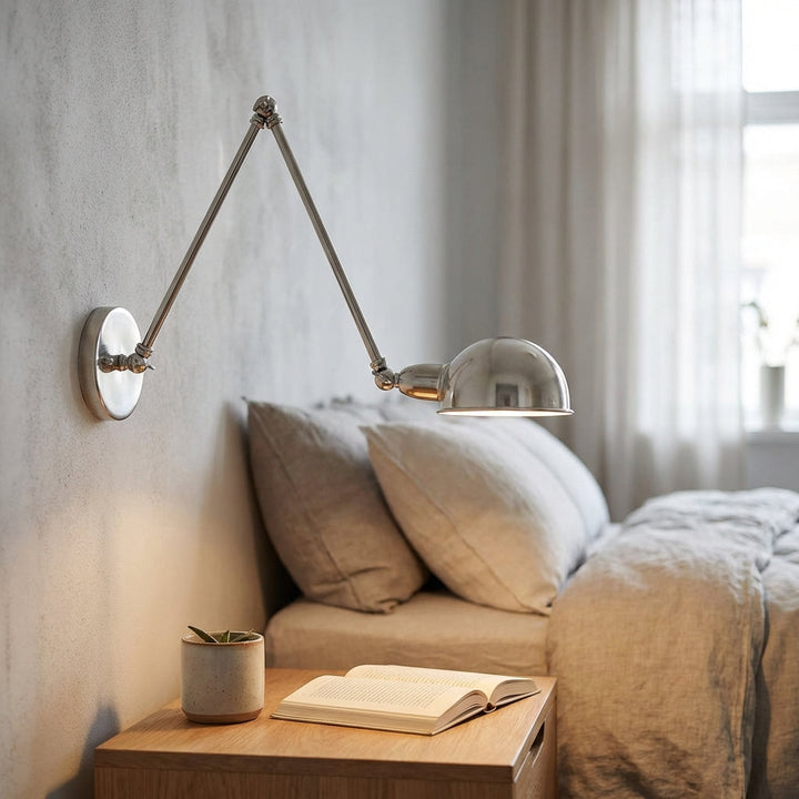 Modern polished silver swing arm wall lamp, adjustable for bedroom task lighting