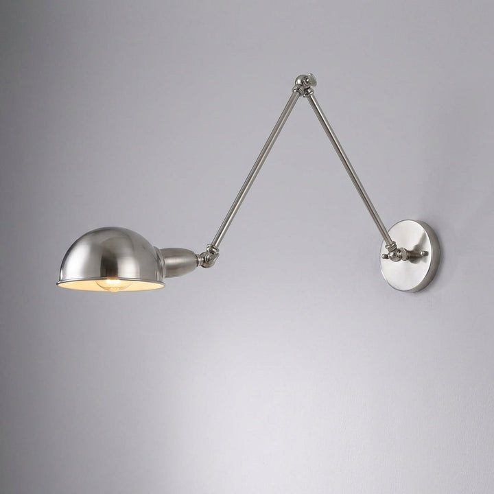 Sleek adjustable swing arm wall lamp in polished silver, ideal for living room decor