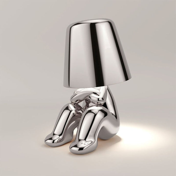 Gold finish LED desk lamp. Rechargeable, touch control, offers modern accent lighting for sophisticated spaces.