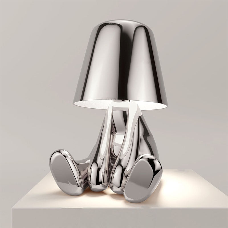 Minimalist silver LED table lamp. Rechargeable, touch control for a modern desk or interior design.
