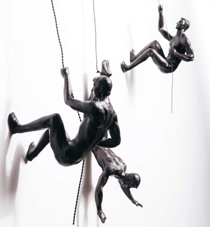 Dynamic climber figure wall sculpture, a unique piece of modern art home decor for any room.