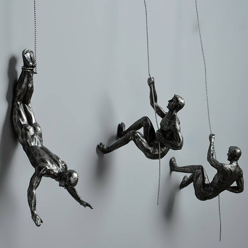 Figurative climber wall art sculpture, a powerful and inspirational modern decor statement piece.