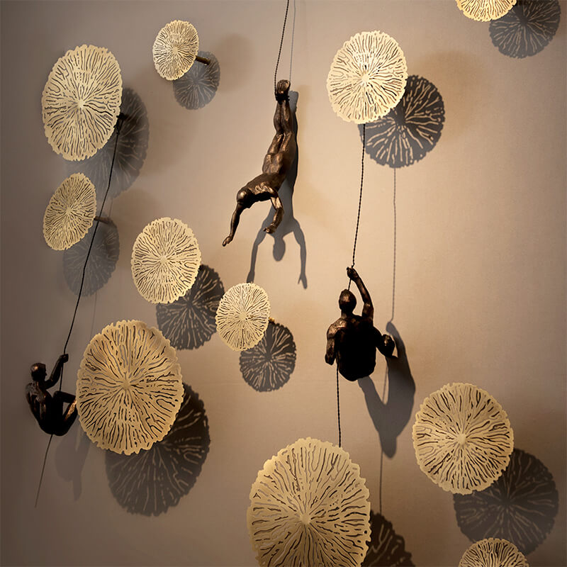 Climber wall sculpture displayed on a wall, modern art home decor adding dynamic flair to interior design.