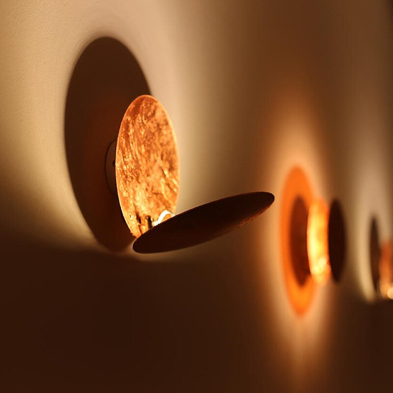Decorative eclipse wall light, metallic gold finish, perfect for contemporary decor.