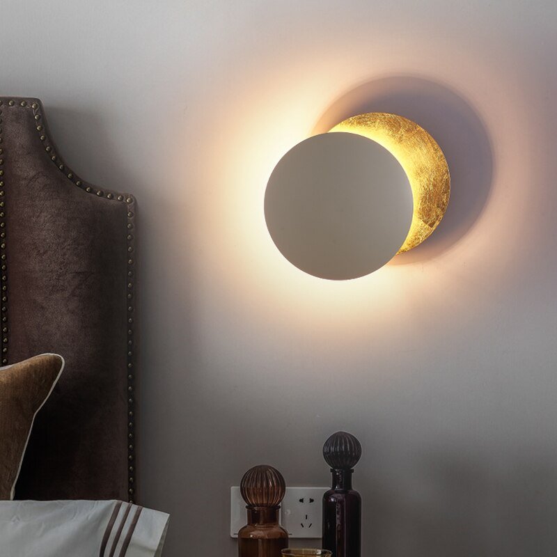 Stylish wall light featuring a solar eclipse motif, providing warm LED ambient lighting.