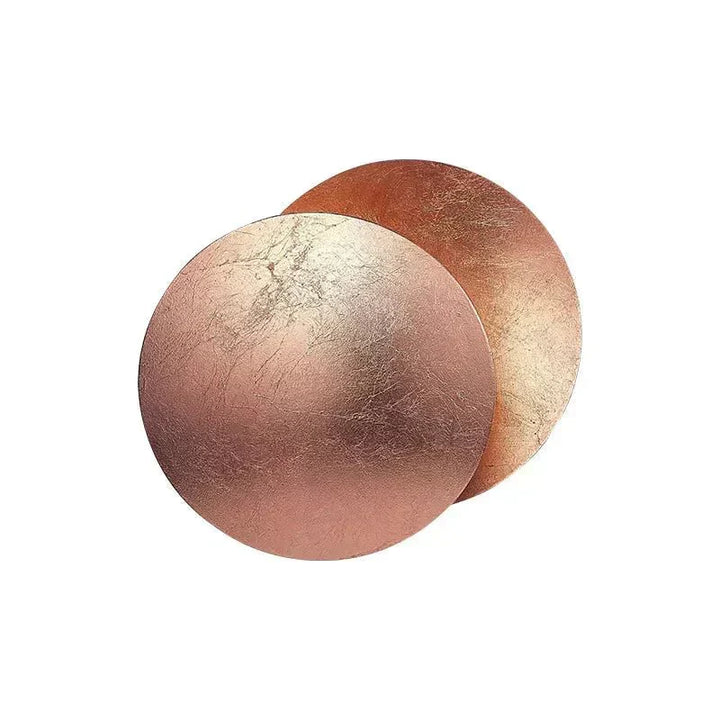 Artistic eclipse-inspired wall light, a decorative metallic home accent with soft LED glow.