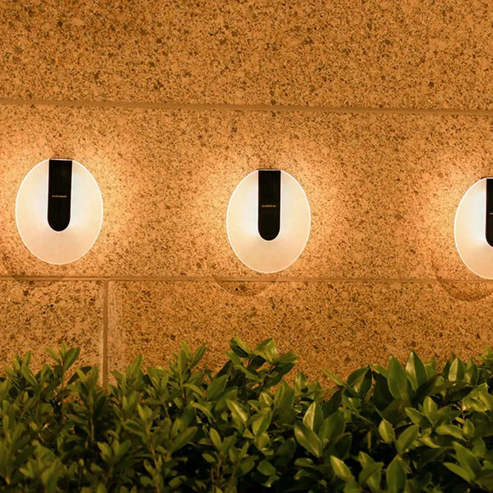 Stylish Solenyx round LED wall sconce, providing ambient light, perfect for modern outdoor decor