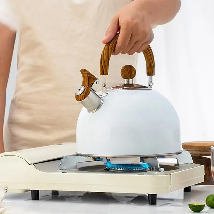 Sleek Kavana stainless steel whistling kettle with black handle, ideal kitchenware for all stovetops.