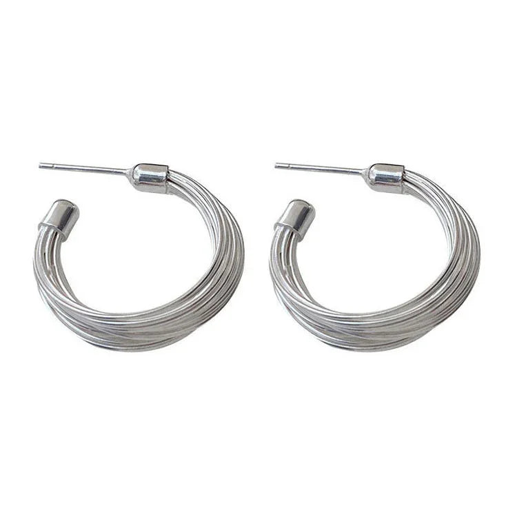 Modern sterling silver hoop earrings for women, featuring a unique layered lines design. Chic contemporary jewelry.