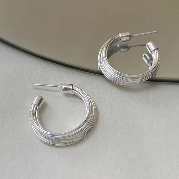 Abstract geometric sterling silver hoop earrings for women. Modern layered lines design, perfect chic jewelry.