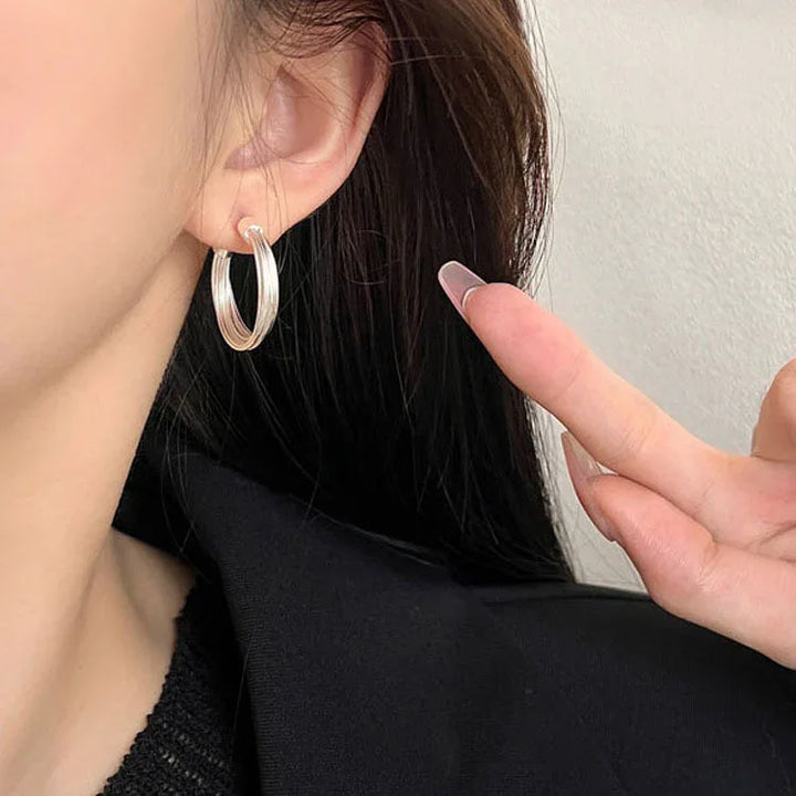 Elegant sterling silver layered lines hoop earrings for women. Modern, chic, and abstract geometric jewelry.