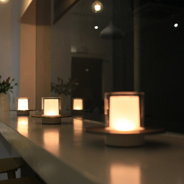 Close-up of a gold LumiFlame wireless LED candle lamp, highlighting its modern design