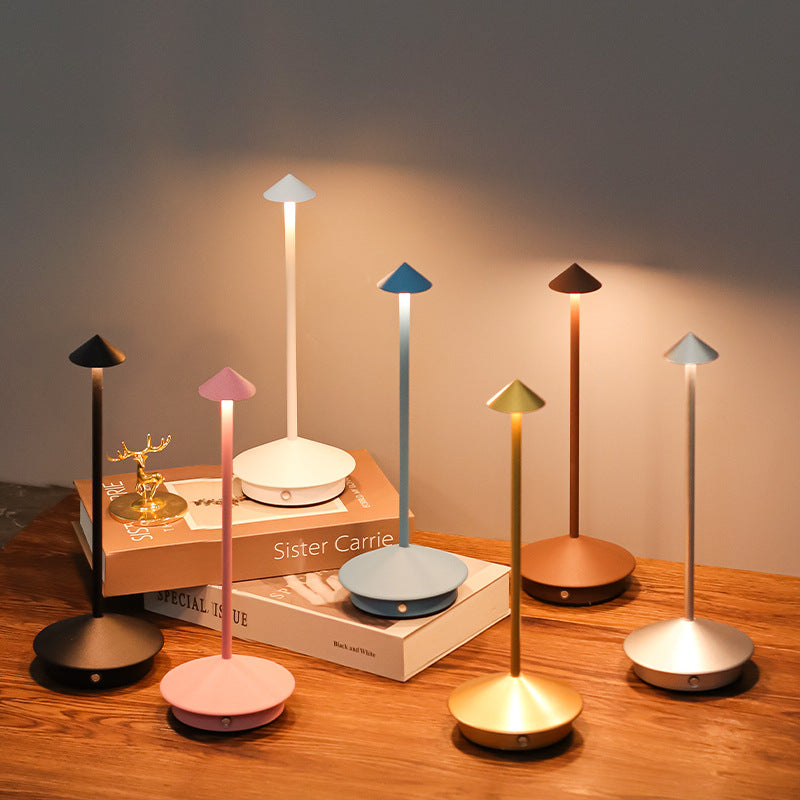 Modern wireless LED table lamp for indoor & outdoor use, dimmable ambient light, touch control, USB rechargeable.