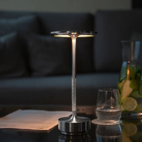 Metallic wireless smart table lamp. Dimmable LED provides modern ambient lighting, perfect for home decor.