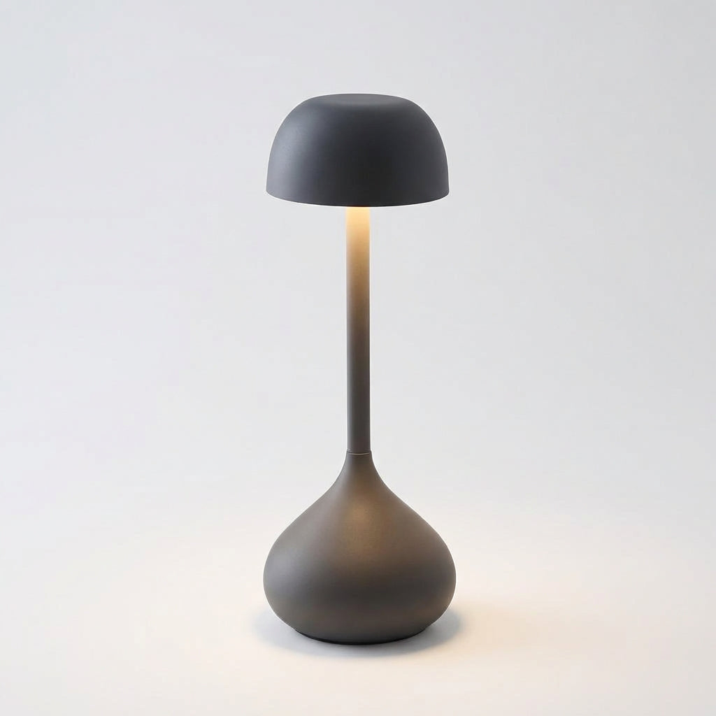 Moonara portable mushroom table lamp on a patio table, demonstrating outdoor use and cordless design