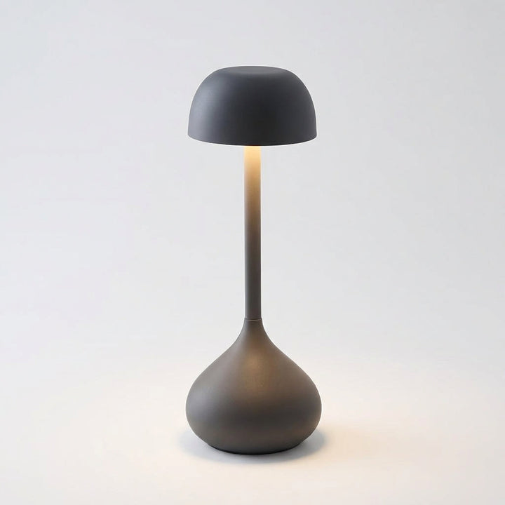 Moonara portable mushroom table lamp on a patio table, demonstrating outdoor use and cordless design