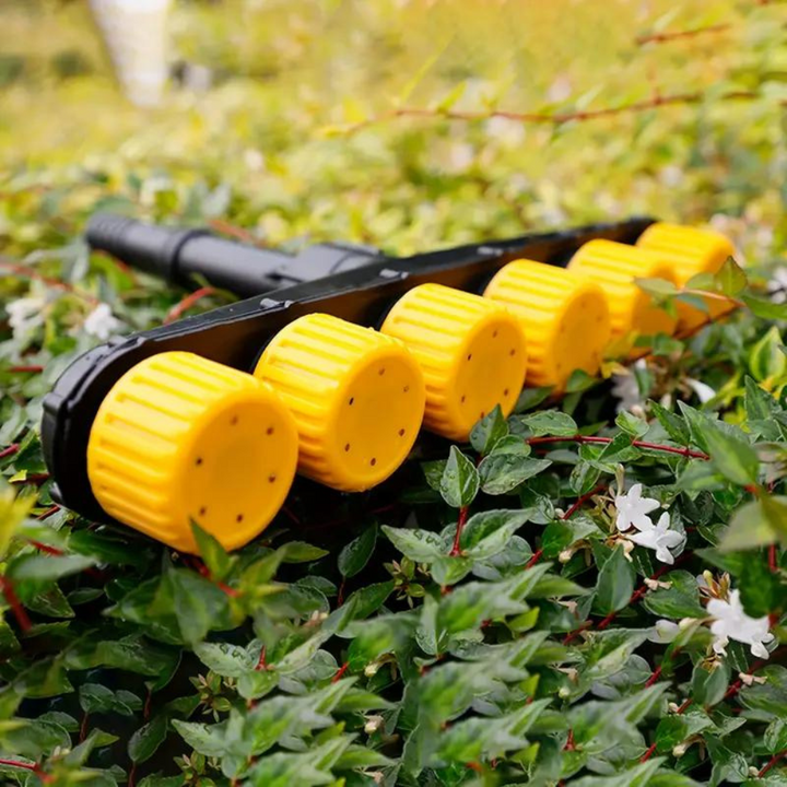 User demonstrates a garden atomizer nozzle, efficiently watering flowers with a gentle, wide spray pattern.