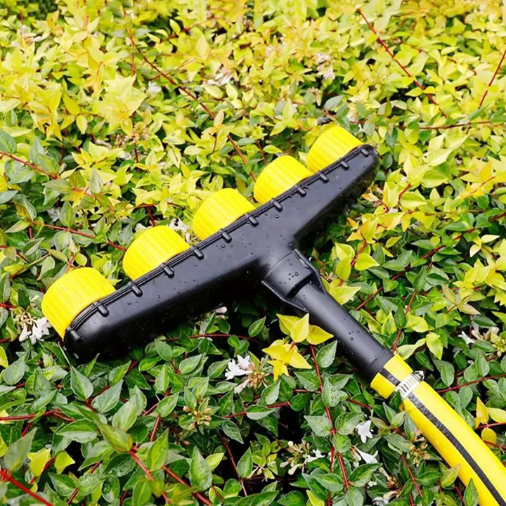 Garden atomizer nozzle spraying fine mist over delicate seedlings for optimal growth & gentle irrigation.