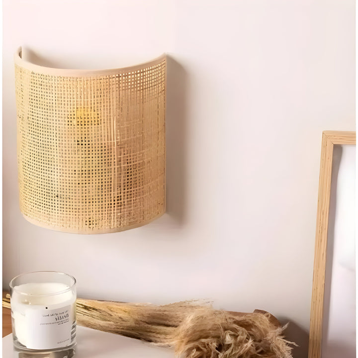 Stylish woven rattan wall sconce, a unique organic lighting fixture for any room.