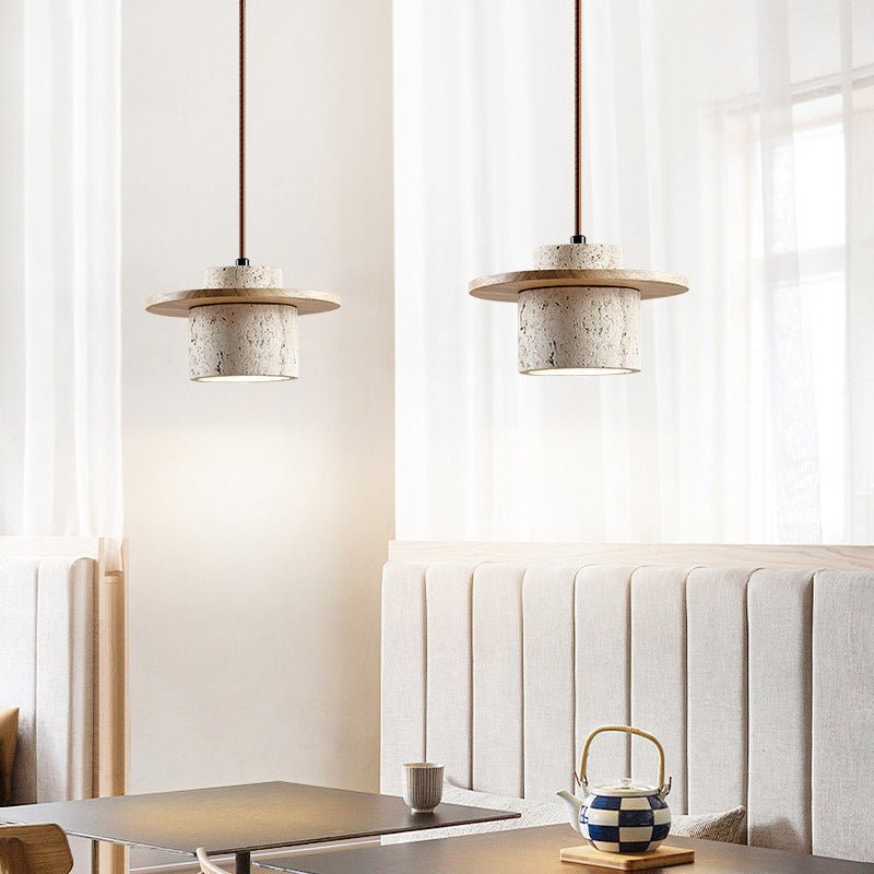 Elegant travertine pendant light, a natural stone fixture for dining room or bedroom luxury lighting.