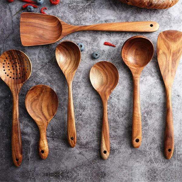 Natural wooden spatula set in action, stirring food. Sustainable, eco-friendly kitchen tools.