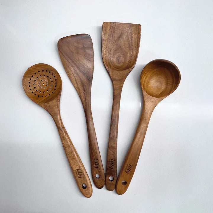 Assortment of natural wooden kitchen tools: spatulas, spoons, and more. Eco-friendly cooking set.