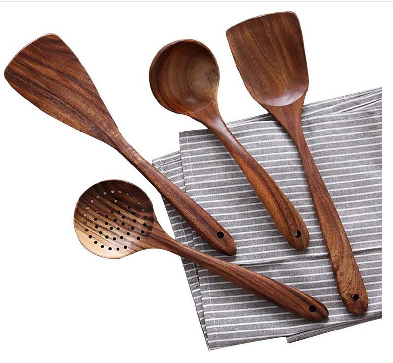 Cooking with natural wood utensils: a spatula, spoon, and other eco-friendly kitchen tools.